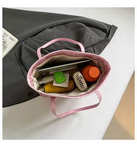 Detail view of pink tote bag with plaid lining showing spacious interior for daily items