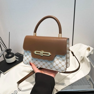 Retro monogram crossbody bag with flap and gold buckle in cream and brown leather