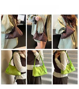 Detail showing vintage suede underarm bag in dark brown and vibrant green colors