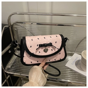 Détails du tissu jacquard rose floral avec bordure en cuir noir et nœud sur le sac