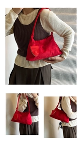 Detail of red suede underarm bag with a matching small coin purse for daily casual wear