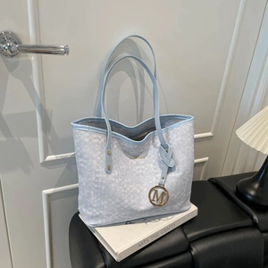 Light blue plaid large tote bag with gold logo and M pendant on black leather seat