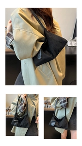 Detail of black canvas underarm bag with unique round flap closure and leather strap