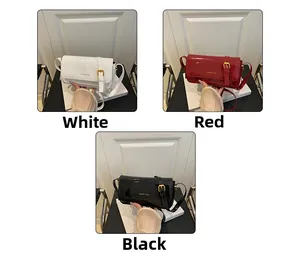 Three patent leather crossbody bags in white, red and black colors with gold buckles