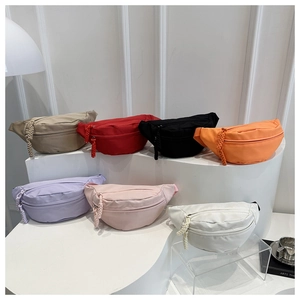 Detailed variety of minimalist canvas waist bags in seven vibrant colors on display