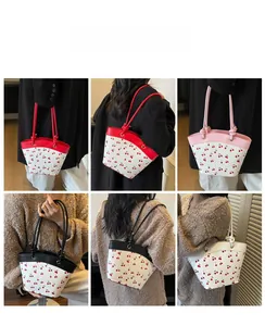 Detail shots of women's shoulder bag with cherry print in red, pink, black and white