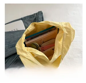 Top view showing the large interior capacity of this light yellow canvas tote bag