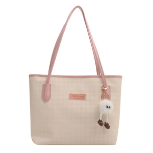 Large beige houndstooth tote bag with pink straps and a cute plush charm accessory