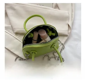 Litchi pattern leather mini shell bag interior showing capacity for cosmetics