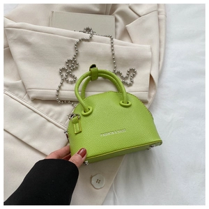 Detail of neon green lychee pattern mini shell bag with silver bead chain strap