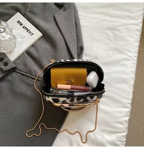 Interior view of zebra print mini bag showing capacity for wallet and cosmetics