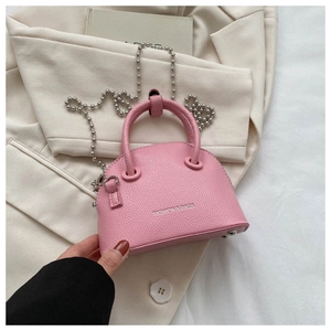 Detailed macro view of pink litchi grain mini shell bag with beaded chain and silver logo