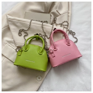 Mini lychee leather shell bags in green and pink with metal ball chain straps