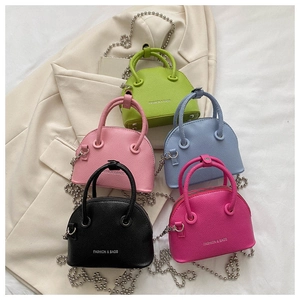 Macro shot of colorful mini litchi pattern shell bags with silver chains and logo details