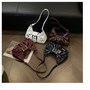 Flat lay of textured patent leather underarm bags in white, brown, burgundy, and black
