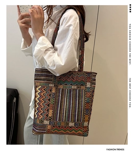 Detailed close-up of ethnic style woven tote bag with colorful geometric patterns