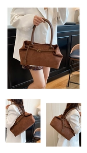 Close-up of vintage brown suede tote bag with fine stitching and metallic hardware details