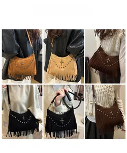 Detail view of four vintage tassel shoulder bags with metallic studs and cross pendants