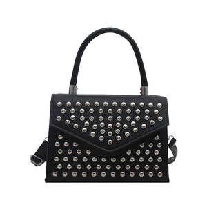 Modern black leather handbag with silver studded V-pattern and curved top handle for women