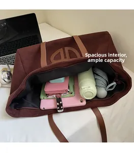Detail view of spacious interior of dark brown suede tote bag with daily essentials