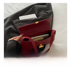 Interior view of deep red pebble leather baguette bag showing capacity for phone and wallet