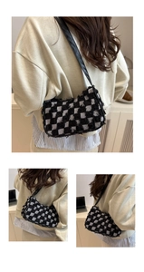 Detail of checkered tweed underarm bag featuring frayed edges and black leather strap