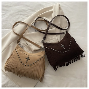 Detail of bohemian fringe crossbody bags with metal studs in light and dark brown