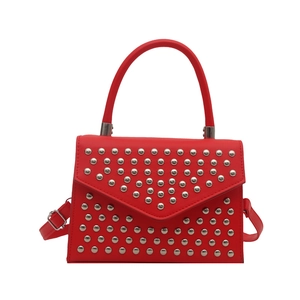 Minimalist red faux leather crossbody bag with silver studs and top handle