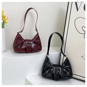 Glossy patent leather shoulder bags in black and wine red with retro pleated details