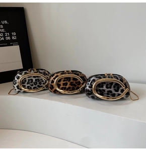 Detailed view of leopard print crossbody bags with golden C-buckle and metal chain straps