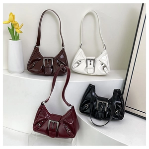 Four colors of pleated patent leather hobo bags with metallic buckle on white background