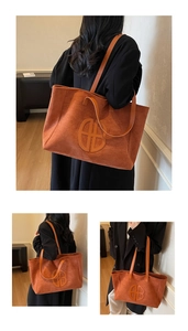 Detail view of large orange suede tote bag with slim straps for casual daily use
