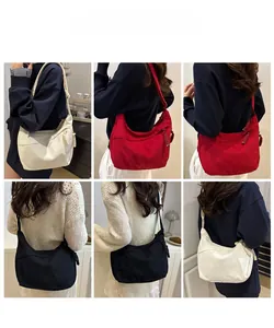 Three-color corduroy crescent bag shown on models in white, red and black finishes