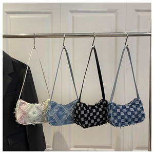 Detail view of denim hobo bags in star and checkerboard patterns with frayed edges