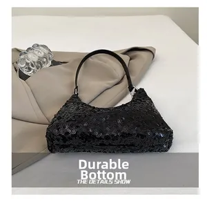 Detailed view of the wear-resistant base and black sequins on this stylish party handbag