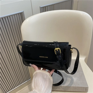 Glossy black patent leather shoulder bag with gold hardware and rectagular flap design