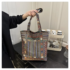 Detail of colorful geometric woven tote bag with ethnic jacquard patterns and strap