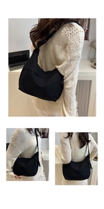 Close-up of black corduroy texture and adjustable strap on a minimalist crossbody bag