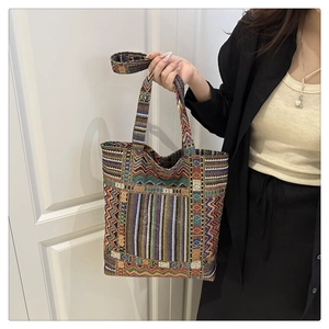 Detailed close-up of ethnic jacquard tote bag with colorful geometric wave pattern