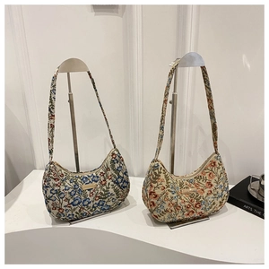 Detailed embroidery texture on vintage floral crescent hobo bags with metal logo plate