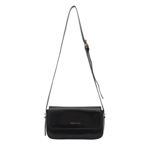 Minimalist black patent leather crossbody bag with gold logo on a clean white background