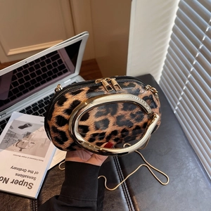 Vintage leopard print square bag with bold gold metal handle and fine chain strap