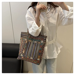 Detail of bohemian geometric pattern canvas tote bag with multi-color woven texture