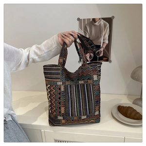 Detail of the colorful geometric woven tote bag with wave and checkerboard patterns