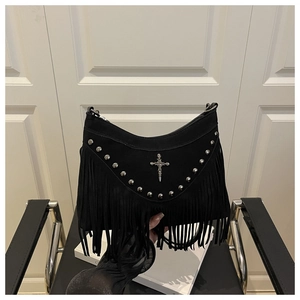 Detail of gothic black suede crescent bag with silver studs, cross clasp, and long tassels