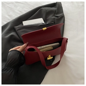Detail showing deep red leather bag interior capacity with phone and wallet inside