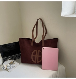 Spacious dark reddish-brown suede tote bag holding a tablet and office accessories