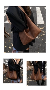 Detailed view of brown woven texture on a large hobo tote bag with a wide shoulder strap