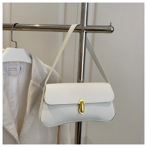 Detail showing white litchi grain leather texture and gold oval clasp on shoulder bag