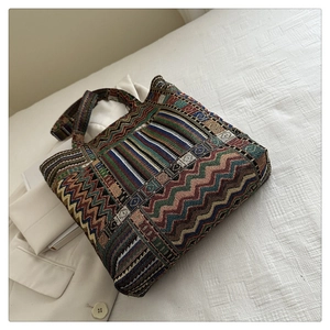 Detail of bohemian tote bag with colorful geometric patterns and woven texture